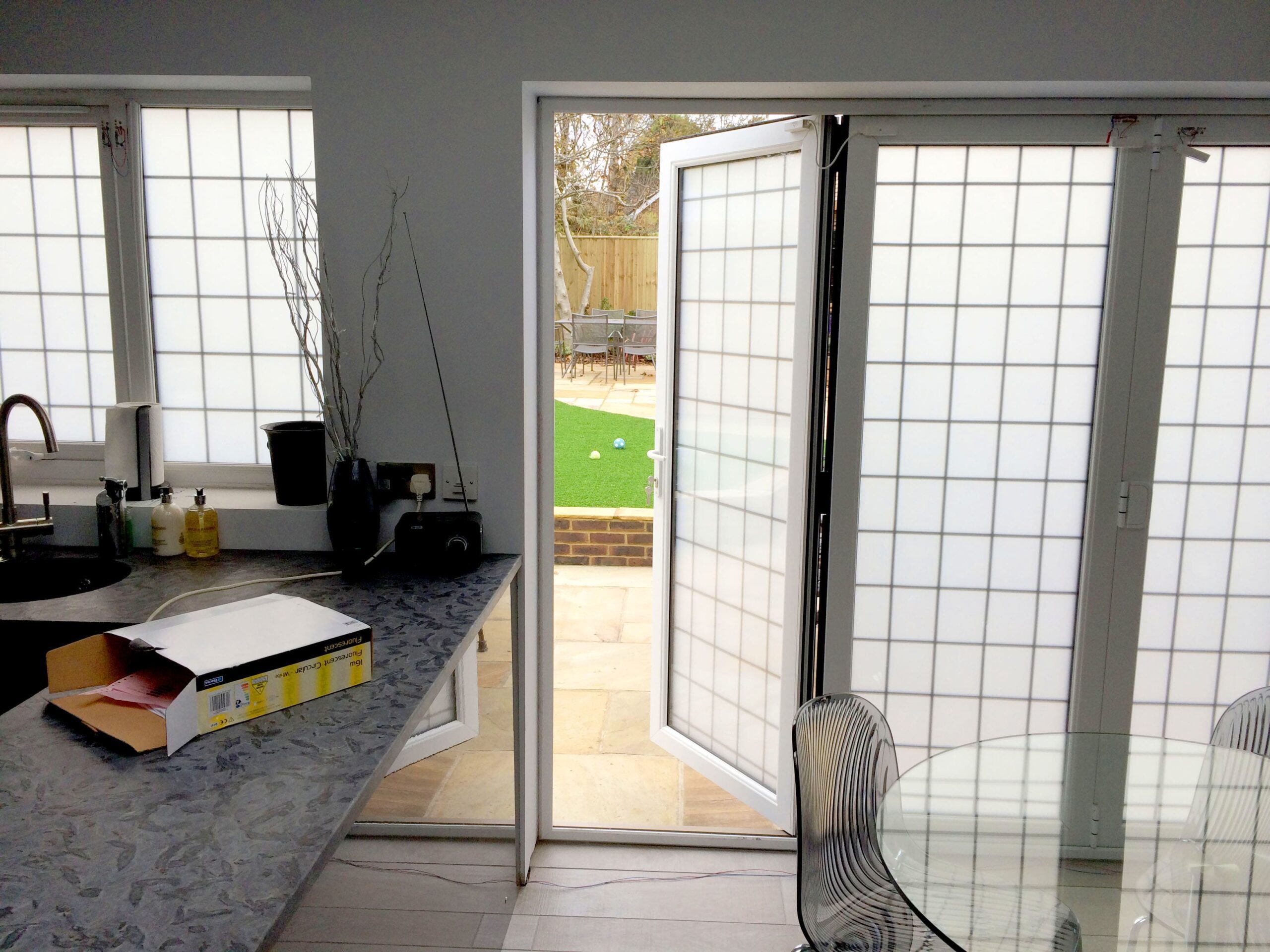 Double Glazed Smart Glass BiFold Doors in a kitchen switched to off